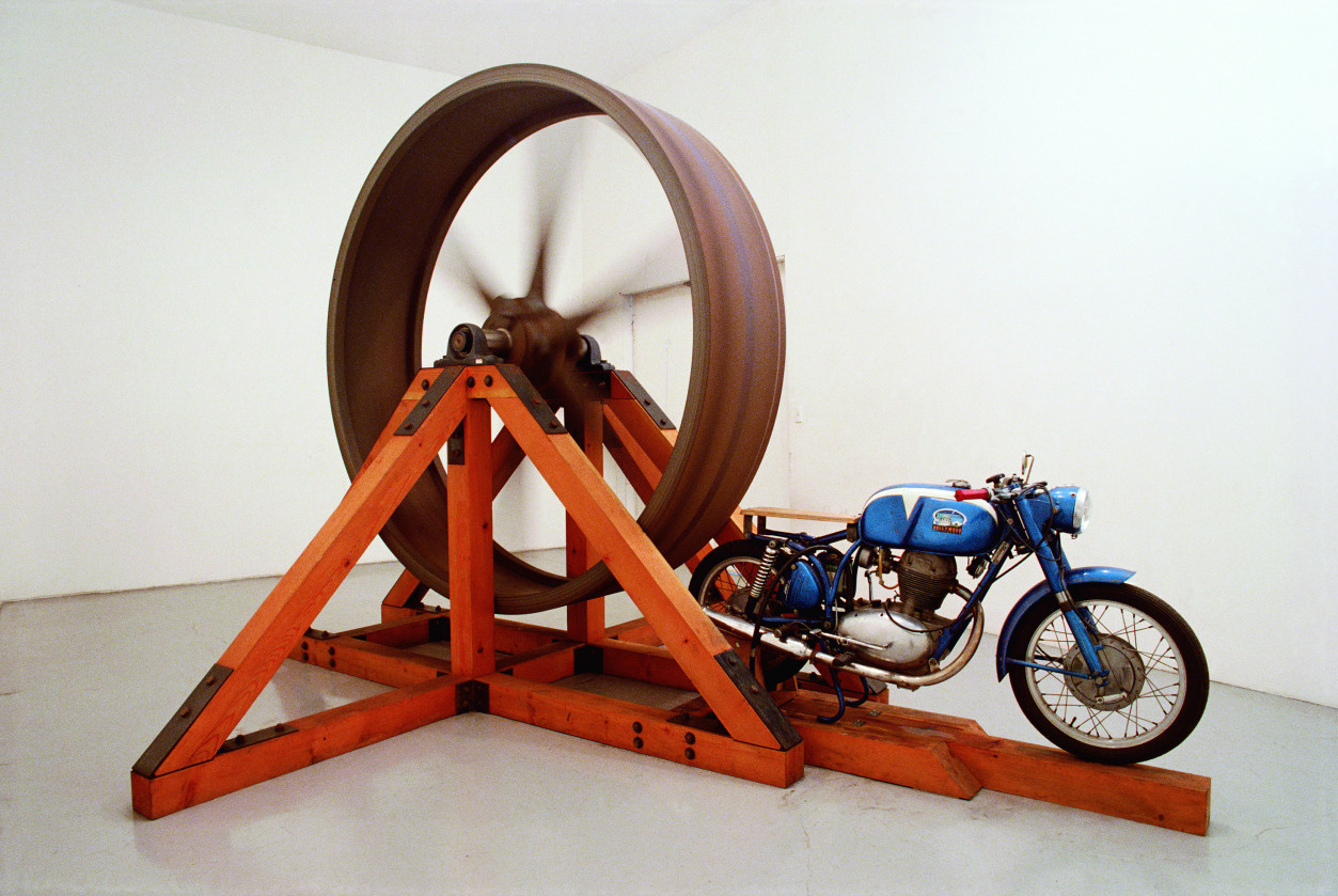 Chris Burden, The Big Wheel, 1979. 3-ton, 8-foot diameter cast iron flywheel powered by a 1968 Benelli 250cc motorcycle.