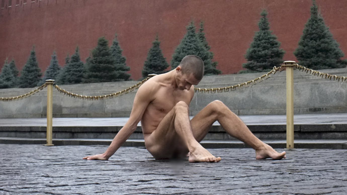 Artist Pyotr Pavlensky sits on the pavestones of Red Square during a protest action in front of the Kremlin wall in central Moscow, November 10, 2013. Pavlensky nailed himself to the pavestones by his genitals as part of an art performance in protest of what he sees as apathy in contemporary Russian society and the possibility such indifference can lead eventually to a police state. The performance coincided with the day when the Interior Ministry honoured its service members. REUTERS/Maxim Zmeyev (RUSSIA - Tags: SOCIETY CIVIL UNREST CITYSCAPE POLITICS ANNIVERSARY) TEMPLATE OUT - RTX157S1