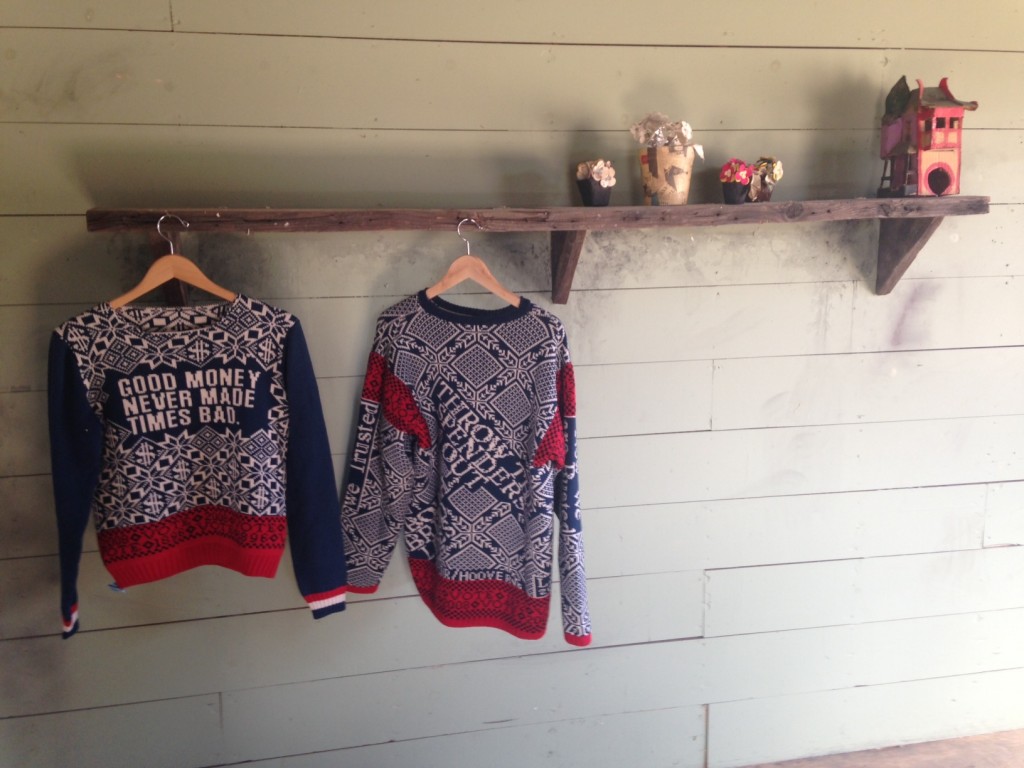 Installation view. Lisa Anne Auerbach sweaters (left). Image courtesy of Bianca Guillen.