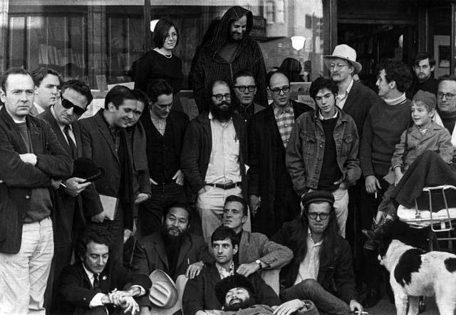 The Last Gathering of the Beats. City Lights Books, 1965. Front Row (Left to right): LaVigne, Murao, Fagin, Meyezove (lying down), Welch, Orlovsky, Homer. Second Row: Meltzer, McClure, Ginsberg, Langton, Steve, Brautigan, Goodrow, Frost. Back Row: Levy, Ferlinghetti.