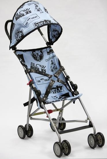 John Waters, "Bill's Stroller," 2014. Umbrella lightweight stroller with silkscreened linen and spiked, leather belt. 39 x 14 x 26 inches. Courtesy of the artist and Marianne Boesky Gallery.