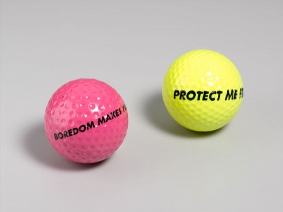 Jenny Holzer, Boredom/Protect golf balls, 1992. Ink on golf ball, 1.75 inches in diameter each. Photo © Lloyd Hryciw. Courtesy of Gregory Lind Gallery.