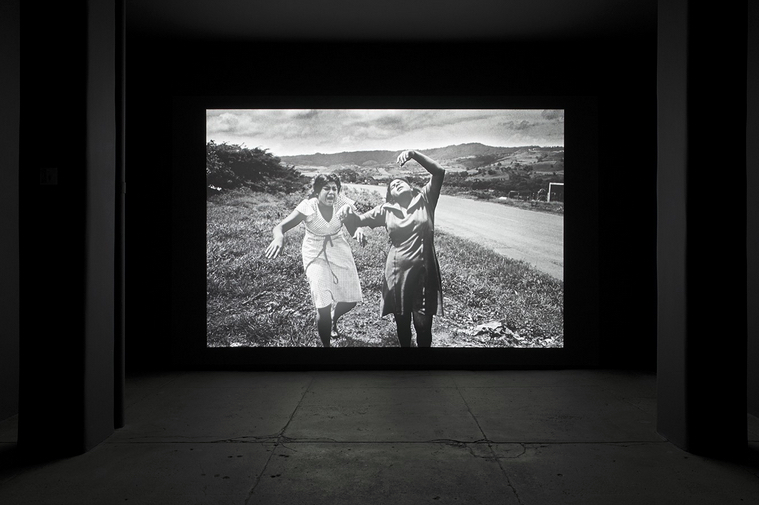 Alfredo Jaar. "Shadows" Installation View, installation with LED lights, aluminum, video projection, 116 x 174 inches. Original photograph by Koen Wessing (1942-2011): Estelí, Nicaragua, September 1978. Courtesy: Galerie Lelong, New York; © Netherlands Fotomuseum, Rotterdam, 2015.