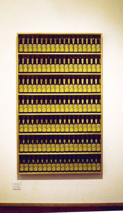 Tom Marioni, Golden Rectangle, 2000. 7 shelves of Pacifico beer bottles, 80 x 51 x 8 inches.