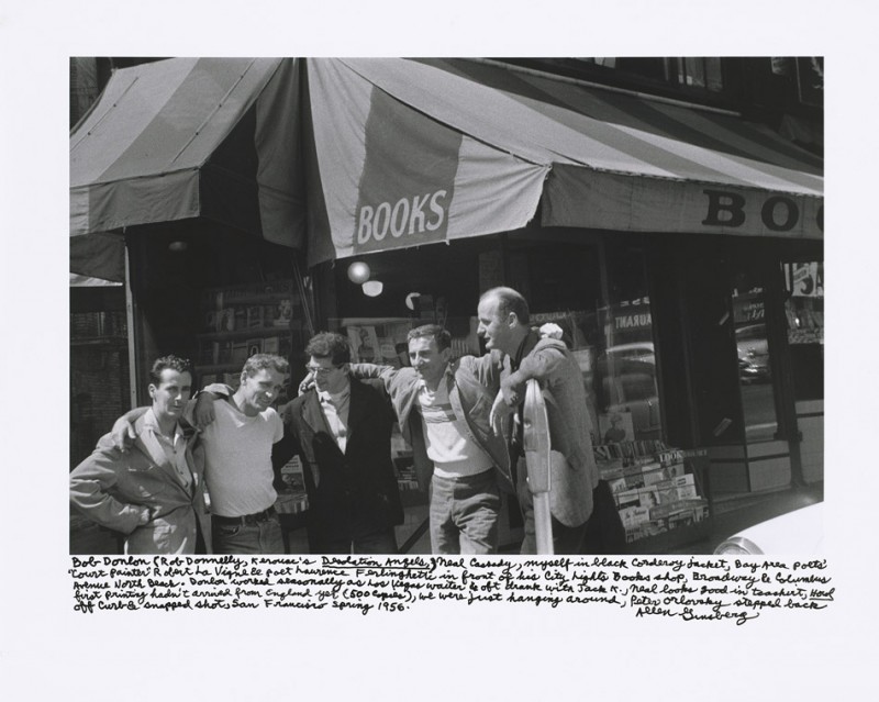 Bob Donlon (Rob Donnelly, Kerouac's Desolation Angels), Neal Cassady, myself in black corduroy jacket, Bay Area poets' "Court Painter" Robert La Vigne & poet Lawrence Ferlinghetti in front of his City Lights Books shop, Broadway & Columbus Avenue North Beach. Donlon worked seasonally as Las Vegas waiter & oft drank with Jack K., Neal looks good in tee shirt, Howl first printing hadn't arrived from England yet (500 copies), we were just hanging around, Peter Orlovsky stepped back off curb & snapped shot, San Francisco spring 1956.