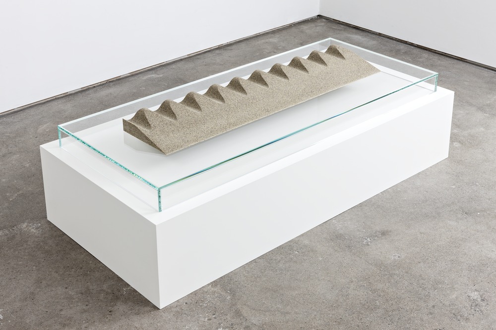 Slice/Wave Fulgurite III.I, 2013. Sand, granite, glass, resin, opal and garnet, cast at Factice. Glass and spray-lacquered wooden plinth. 2.375 x 42 x 9.75 inches. Courtesy of Standard (Oslo). Photograph by Vegard Kleven.