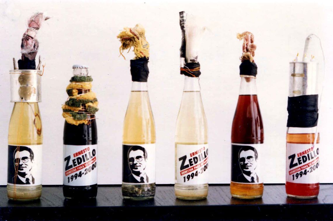 Vicente Razo, Revolucionario institucional (Institutional Revolutionary), 1994. Molotov cocktails in six propaganda glass bottles and mixed media, dimensions variable. Courtesy of the artist and Moore College of Art & Design.