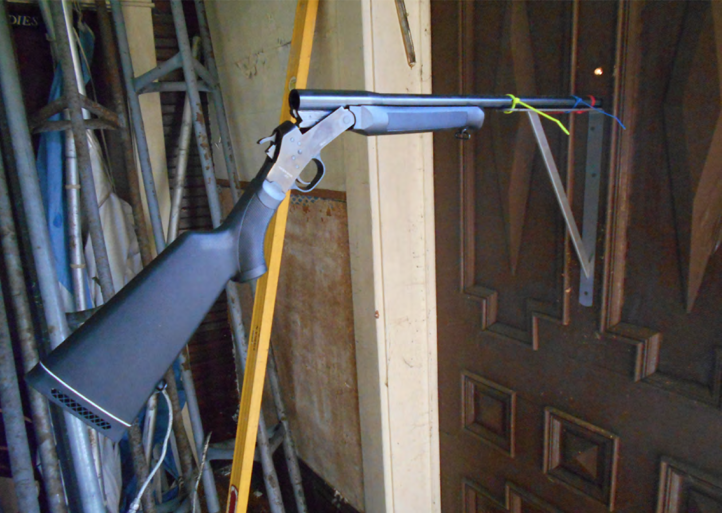 POINT BLANK, 2014. 12 gauge shotgun installed in shut door. Courtesy of the artist.