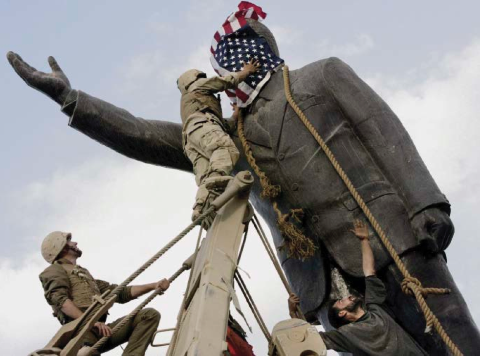 A statue of Saddam Hussein being toppled in Firdos Square, downtown Baghdad, on 9 April 2003.