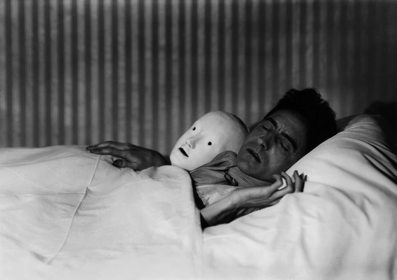 Berenice Abbott, Cocteau in Bed with Mask, Paris, 1927. Gelatin silver print, 10.5 x 13.5 inches. Courtesy of Cheim & Read.