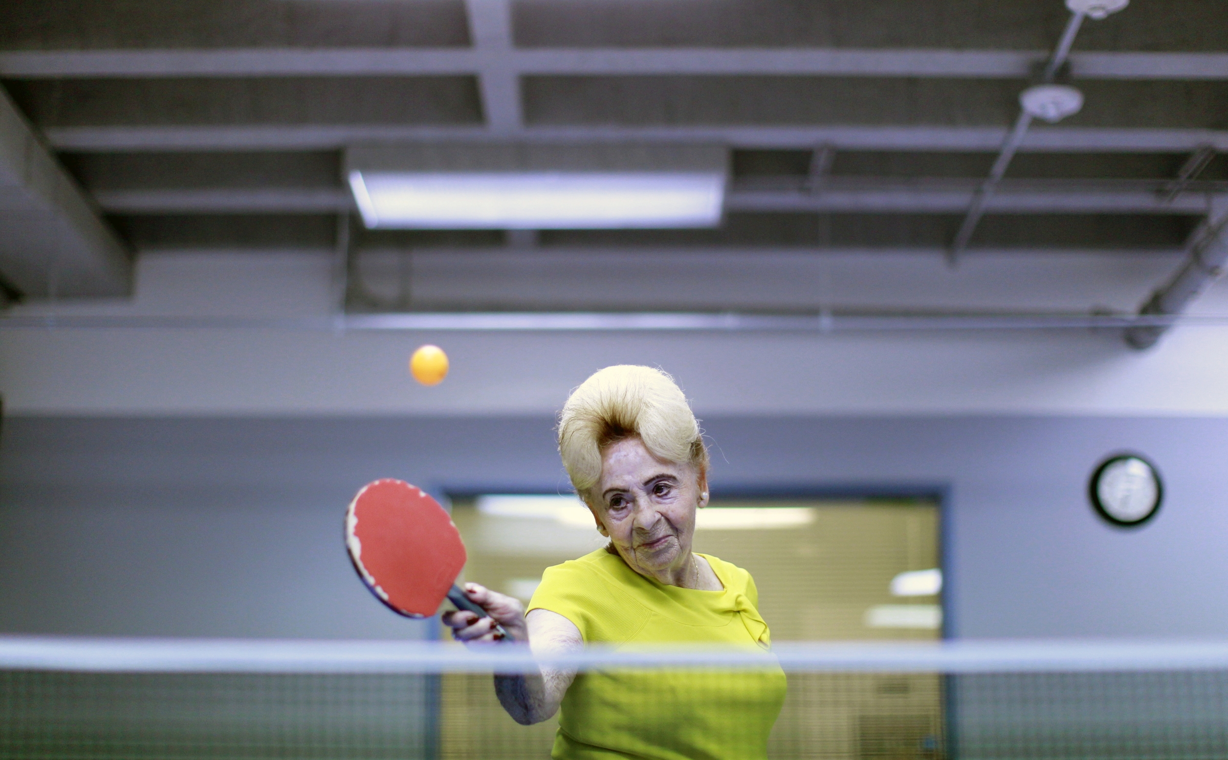 Lucy Nicholson,(American/British, born England), Alzheimer’s Ping Pong Therapy, Los Angeles, CA, 2011, printed 2016. Inkjet print, 10 5/8 x 16 3/8 in. Courtesy of Lucy Nicholson/Reuters and the Brooklyn Museum.