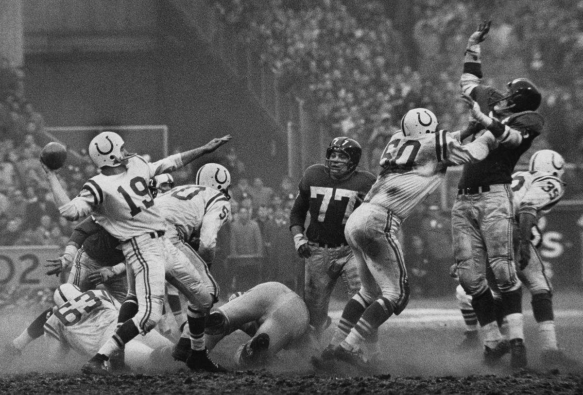 Robert Riger (American, 1924–1995), The Golden Arm, Johnny Unitas, 1958. Gelatin silver print, 12 3/4 x 18 1/4 inches. Collection of the artist. © Robert Riger. Courtesy of the Robert Riger Living Trust and the Brooklyn Museum.