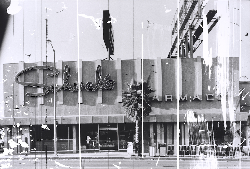 Ed Ruscha, Schwab’s Pharmacy, 1976, from "The Sunset Strip, series published in 1995. Gelatin silver print from altered negative, 20 x 30 inches. Published by Patrick Painter Editions, Vancouver and Hong Kong. Collection of the Fine Arts Museums of San Francisco. Museum purchase, Mrs. Paul L. Wattis Fund, 2000.131.193 © Ed Ruscha. Courtesy of the Fine Arts Museums of San Francisco.