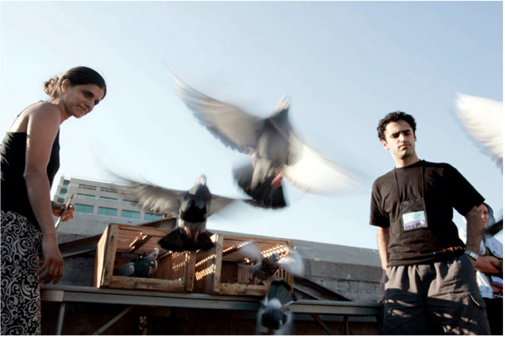 Beatriz da Costa and some of her pigeons. Courtesy of the artist and MIT.