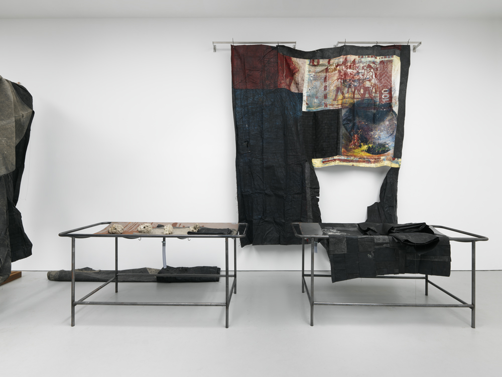 a futile mercantile disposition, 2016. Oil and oil stick on canvas and linen, stainless steel, vinyl, latex, copper, PVC tubing, self-hardening clay with ground corn, and single channel video, dimensions vary with installation. Courtesy of David Zwirner. 