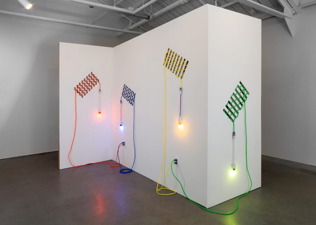 Dana Hemenway. Untitled (Drywall Weave), 2016; Laser cut drywall, wood, extension cords, custom fixtures, colored compact fluorescent light  bulbs; 96 x 108 x 84 inches. Courtesy of the artist and Eleanor Harwood Gallery, San Francisco.