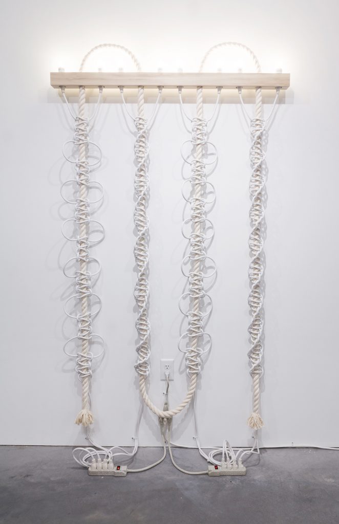 Dana Hemenway. Untitled (White Extension Cords, Rope), 2016; cotton rope, white extension cords, wood, compact fluorescent light bulbs, zip ties,  power strips, paint; 77 x 48 x 3.5 inches. Courtesy of the artist and Eleanor Harwood Gallery, San Francisco.